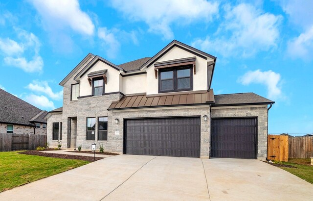 view of front of house with a garage and a front lawn