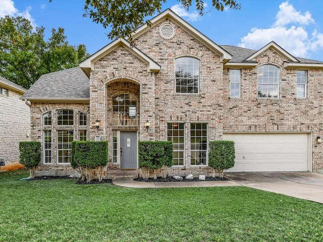 view of front of home featuring a front yard and a garage