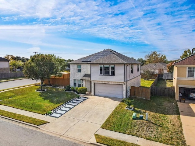 view of front of house featuring solar panels, a front lawn, and a garage