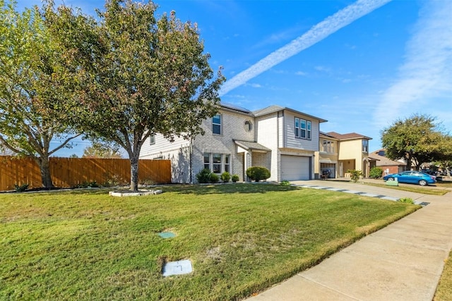 view of front of home featuring a garage and a front lawn