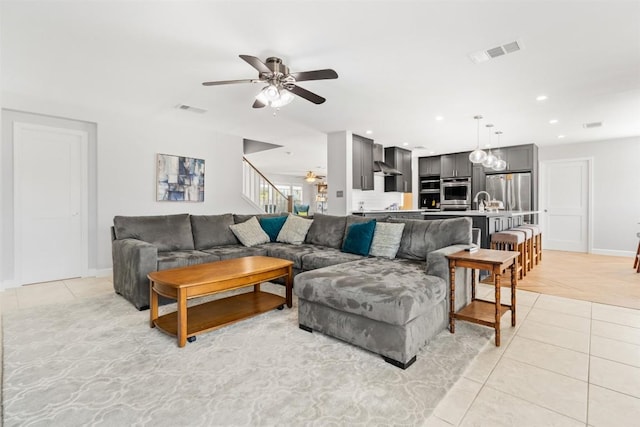 tiled living room with ceiling fan