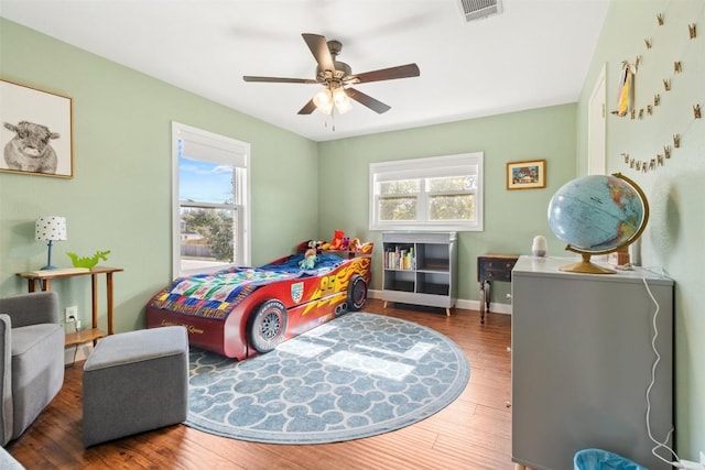 bedroom featuring ceiling fan and dark hardwood / wood-style floors