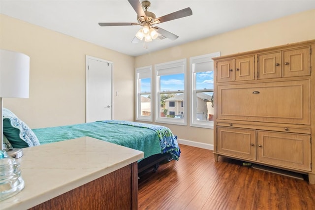 bedroom featuring dark hardwood / wood-style floors and ceiling fan