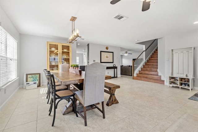 tiled dining space featuring ceiling fan