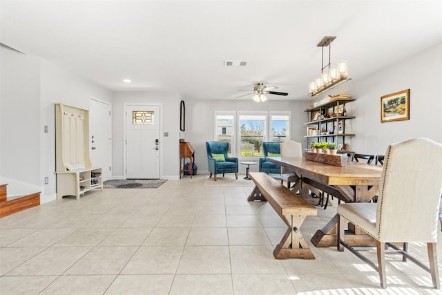 tiled dining space featuring ceiling fan