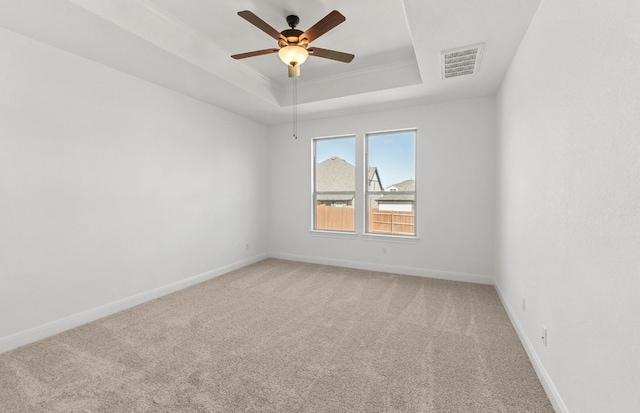 217 Canyoncrest Way, Liberty Hill, TX 78642 - empty room with light colored carpet, a ceiling fan, a raised ceiling, and crown molding