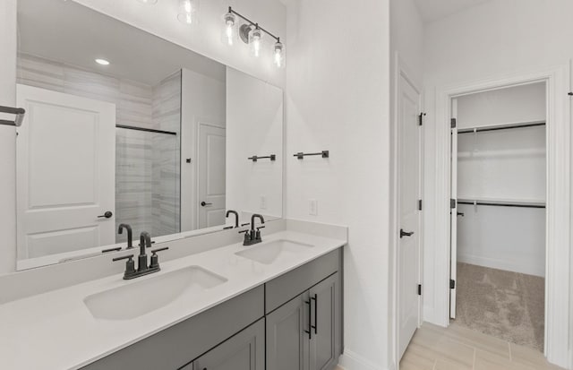 217 Canyoncrest Way, Liberty Hill, TX 78642 - full bathroom with double vanity, a tile shower, and a walk in closet