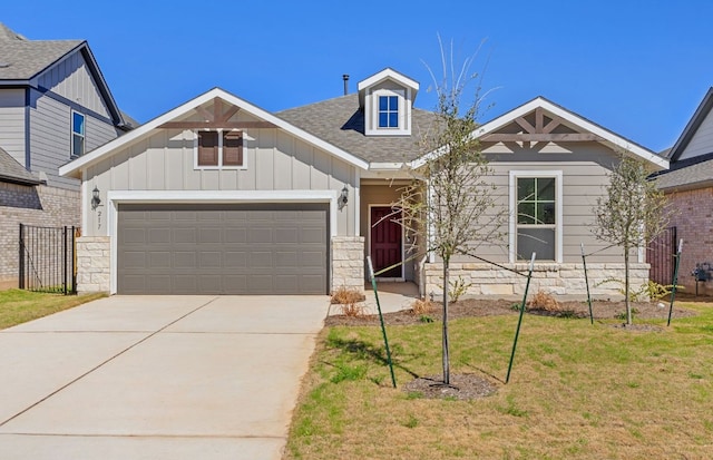 217 Canyoncrest Way, Liberty Hill, TX 78642 - craftsman-style home featuring an attached garage, concrete driveway, board and batten siding, a front yard, and a shingled roof