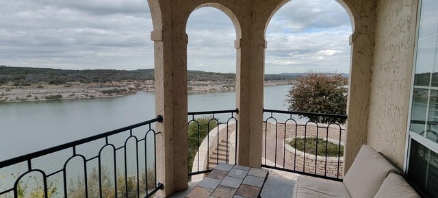 balcony featuring a water view