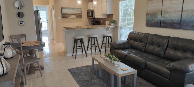 living room with light tile patterned flooring