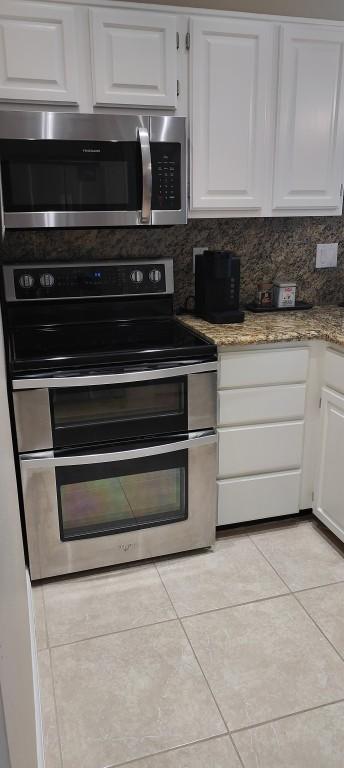 kitchen featuring white cabinetry and appliances with stainless steel finishes