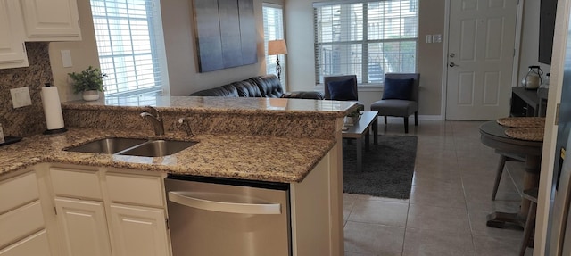 kitchen featuring kitchen peninsula, a wealth of natural light, sink, and white cabinets