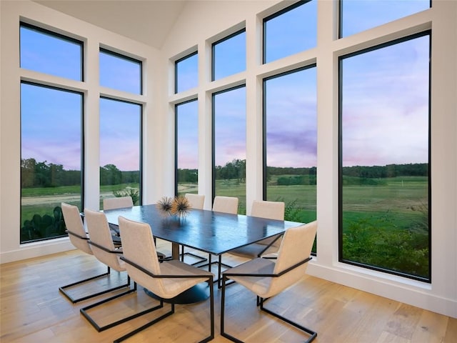 sunroom / solarium featuring vaulted ceiling