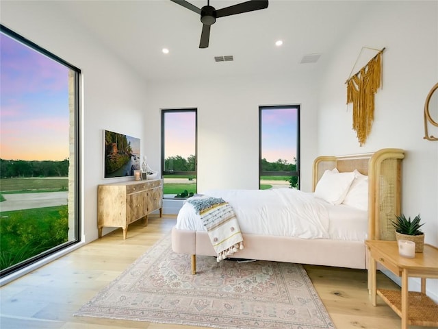 bedroom with light wood-type flooring and ceiling fan