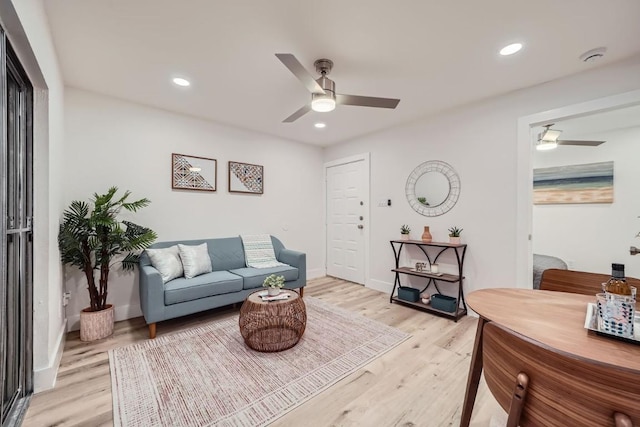 living room featuring ceiling fan and light wood-type flooring