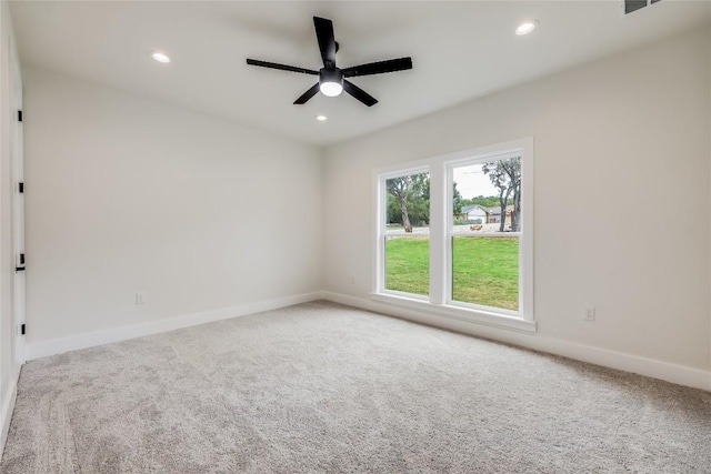 carpeted spare room with ceiling fan