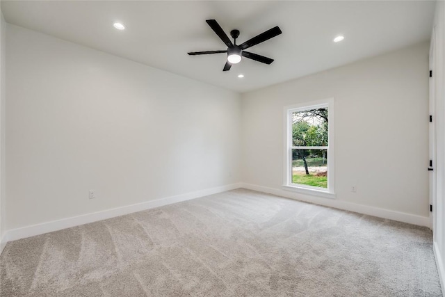 carpeted empty room featuring ceiling fan