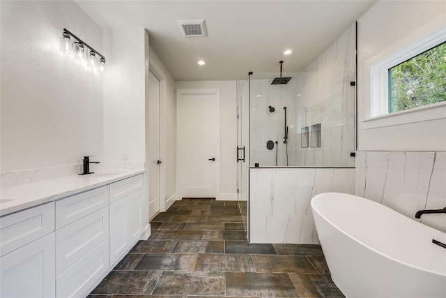 bathroom featuring separate shower and tub and vanity