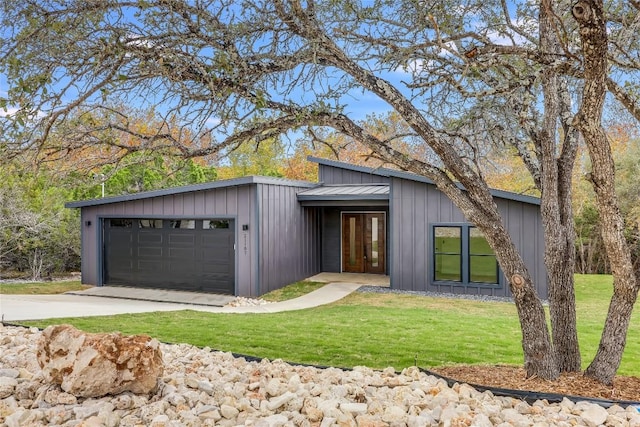 view of front of house featuring a front yard, french doors, and a garage