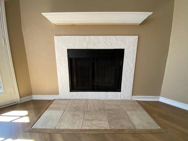 1005 N Lbj Dr Unit A-5, San Marcos, TX 78666 - detailed view of wood finished floors, a fireplace with flush hearth, and baseboards