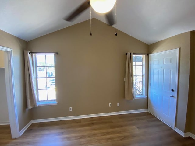 1005 N Lbj Dr Unit A-5, San Marcos, TX 78666 - unfurnished bedroom with lofted ceiling, wood finished floors, multiple windows, and baseboards