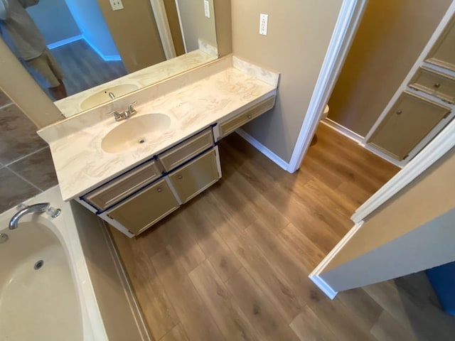 1005 N Lbj Dr Unit A-5, San Marcos, TX 78666 - full bath featuring vanity, wood finished floors, a tub, baseboards, and toilet