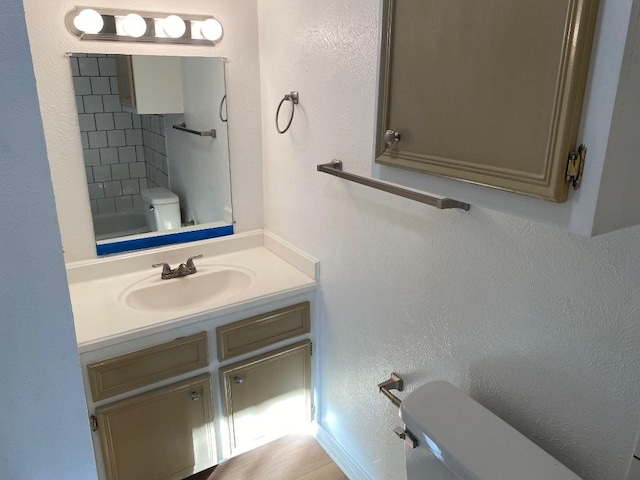 1005 N Lbj Dr Unit A-5, San Marcos, TX 78666 - bathroom featuring toilet, vanity, a textured wall, a bath, and a shower