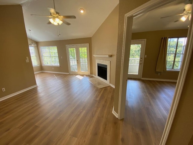 1005 N Lbj Dr Unit A-5, San Marcos, TX 78666 - unfurnished living room with a ceiling fan, vaulted ceiling, baseboards, and plenty of natural light