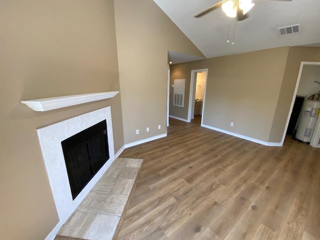 1005 N Lbj Dr Unit A-5, San Marcos, TX 78666 - unfurnished living room with electric water heater, ceiling fan, wood finished floors, lofted ceiling, and baseboards