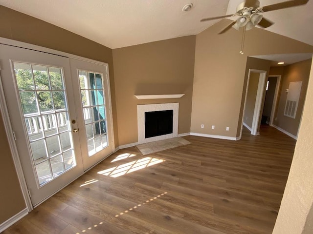 1005 N Lbj Dr Unit A-5, San Marcos, TX 78666 - unfurnished living room featuring lofted ceiling, wood finished floors, baseboards, french doors, and ceiling fan