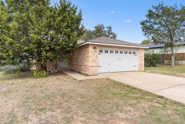 exterior space featuring a front lawn and a garage