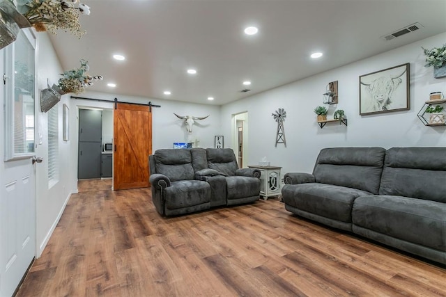 living room featuring hardwood / wood-style floors and a barn door