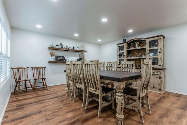 dining area featuring a healthy amount of sunlight and dark hardwood / wood-style flooring