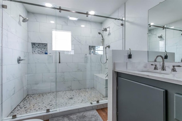 bathroom featuring hardwood / wood-style floors, vanity, and an enclosed shower