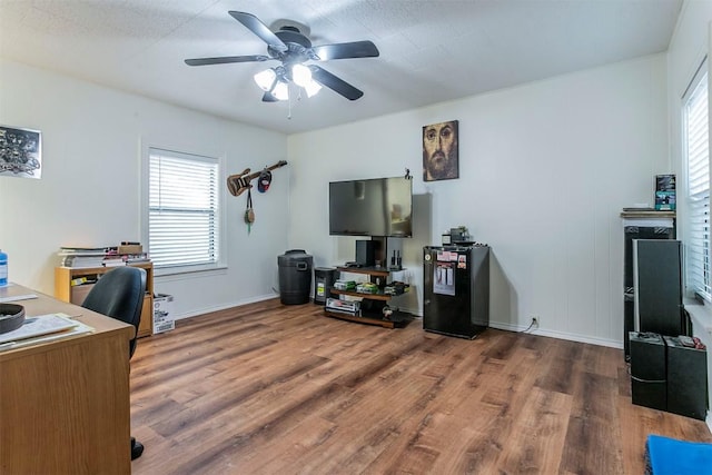 home office featuring hardwood / wood-style flooring, ceiling fan, and a wealth of natural light