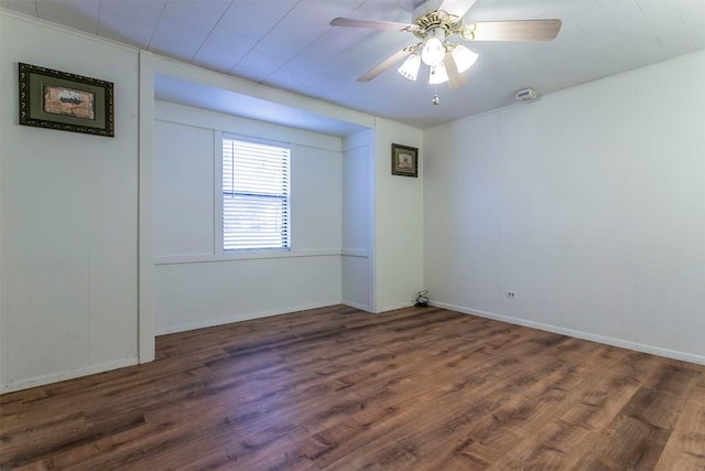 empty room with ceiling fan and dark wood-type flooring