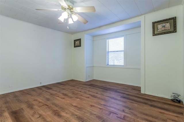 empty room with dark hardwood / wood-style flooring and ceiling fan