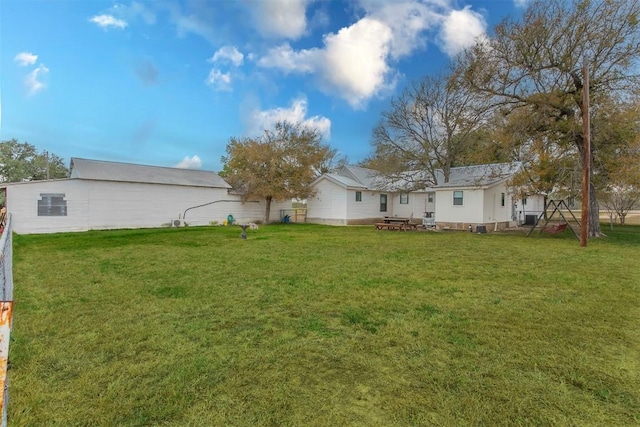 back of house with a lawn