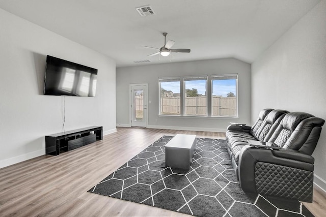 living room with wood-type flooring, ceiling fan, and lofted ceiling