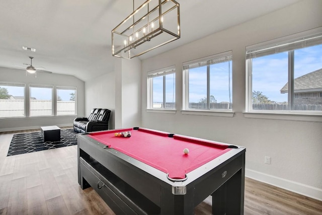 game room with ceiling fan, plenty of natural light, wood-type flooring, and vaulted ceiling