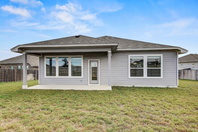 100 Patrick Herndon Dr, Bastrop, TX 78602 - back of property featuring a patio area and a shingled roof
