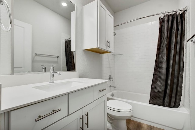 full bathroom featuring hardwood / wood-style floors, vanity, toilet, and shower / bathtub combination with curtain