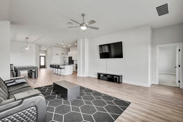 100 Patrick Herndon Dr, Bastrop, TX 78602 - living room with wood finished floors, ceiling fan, baseboards, and recessed lighting