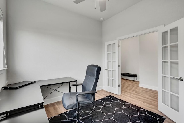 office with french doors, ceiling fan, and wood-type flooring