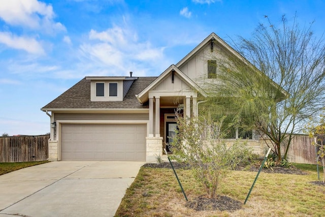 100 Patrick Herndon Dr, Bastrop, TX 78602 - craftsman-style home with a shingled roof, driveway, a garage, and stone siding
