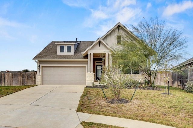 craftsman house featuring a front lawn and a garage