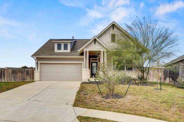 100 Patrick Herndon Dr, Bastrop, TX 78602 - view of front of house featuring driveway, an attached garage, and a shingled roof