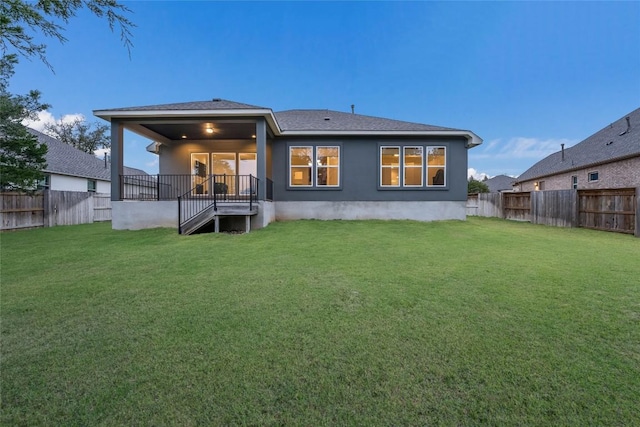 back of house with a lawn