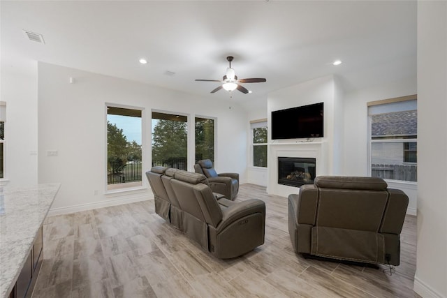 living room with ceiling fan and light hardwood / wood-style floors