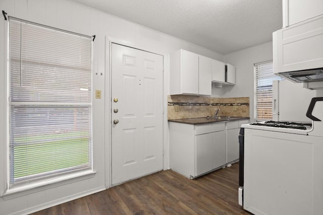 kitchen featuring white cabinets, white appliances, dark wood-type flooring, and a textured ceiling